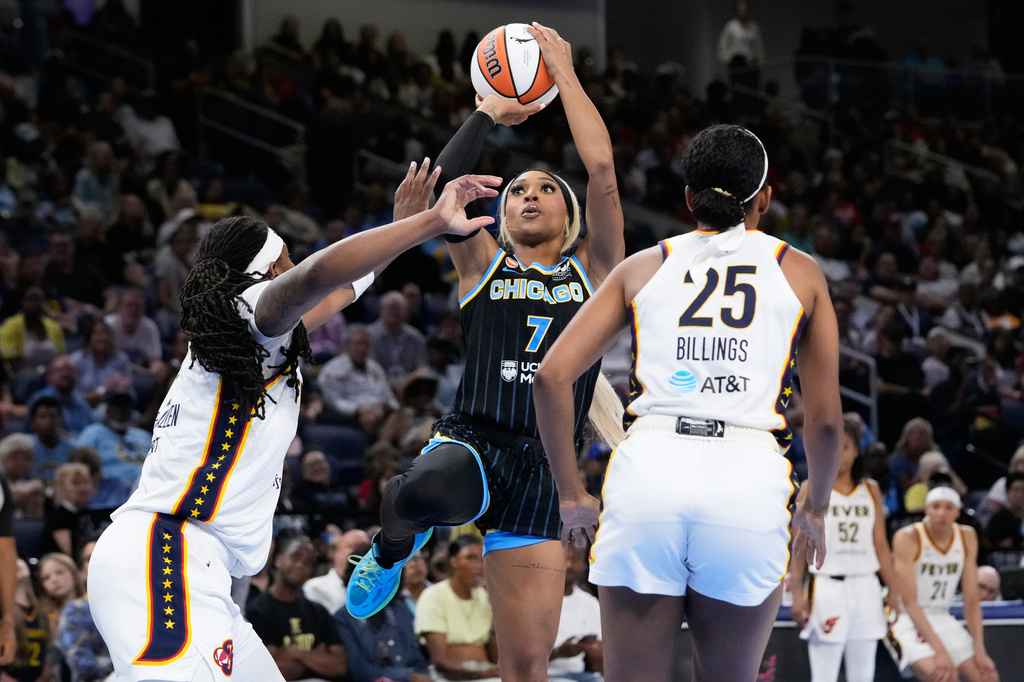 Chicago Sky guard-forward DiJonai Carrington, center, shoots against Indiana Fever forward Myisha Hines-Allen, left, and forward Monique Billings during the second half of a WNBA basketball game Sunday, Aug. 23, 2026, in Chicago. (AP Photo/Nam Y. Huh)
