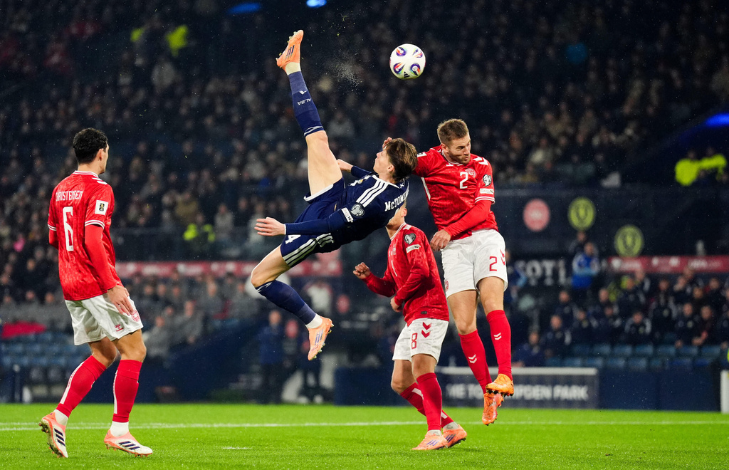 Scotland's Scott McTominay scores the opening goal with an overhead kick during the 2026 World Cup European Qualifying soccer match between Scotland and Denmark at Hampden Park, Glasgow, Scotland, Tuesday, Nov. 18, 2025. (Andrew Milligan/PA via AP)