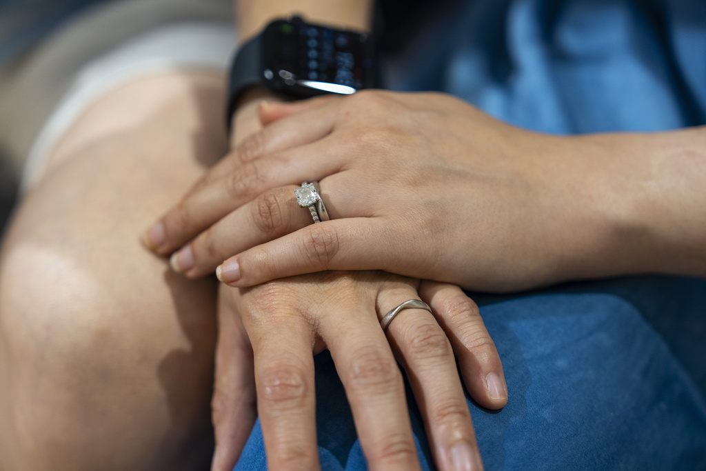 Same-sex partners Jaedyn Yu, right, and Gloria Tsang wear their wedding rings in Hong Kong, Sunday, Aug. 24, 2025. (AP Photo/Chan Long Hei)