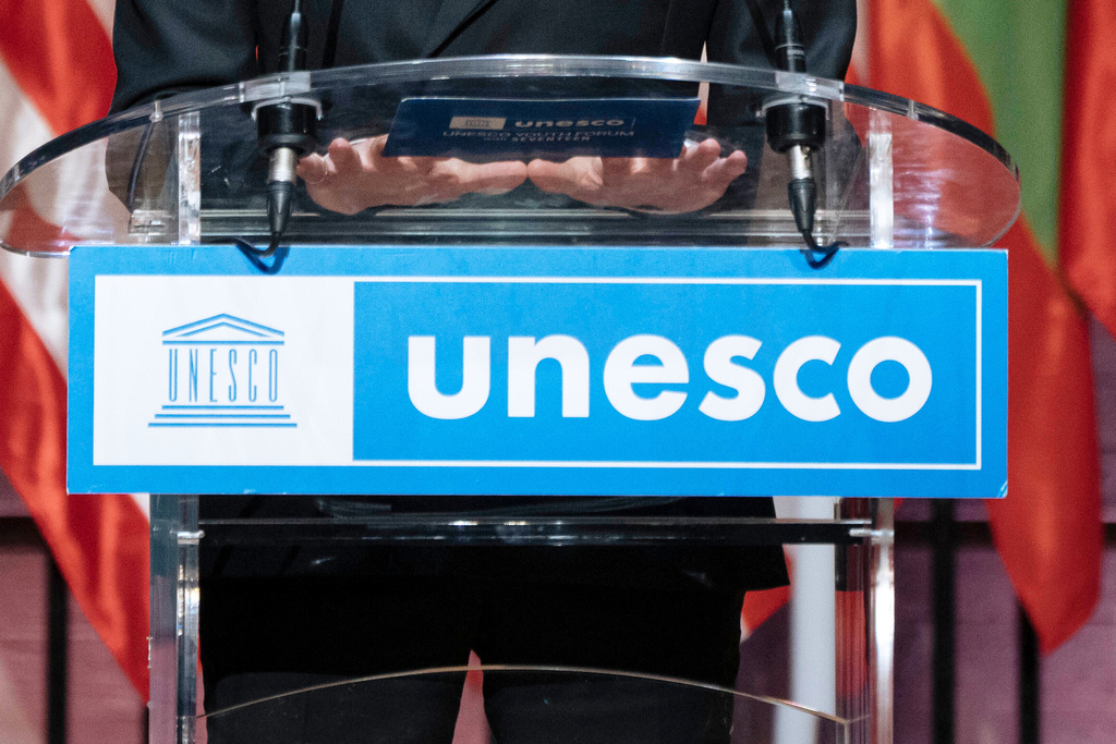 FILE - The UNESCO logo hangs from a podium in Paris, Nov. 14, 2023. (AP Photo/Lewis Joly, File)