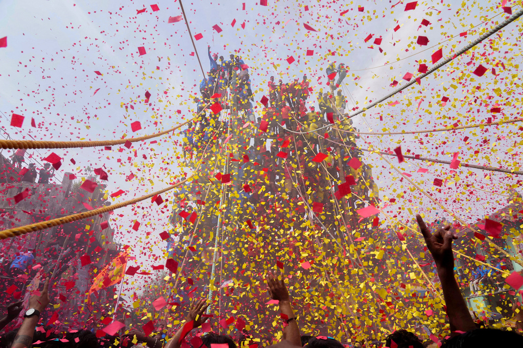 Members of the Agri-Koli community celebrate as they compete to erect ceremonial bamboo poles in a centuries-old annual tradition honoring the local goddess Raiba Devi, in Rave village, near Mumbai, India, Friday, April 17, 2026. (AP Photo/Rafiq Maqbool)