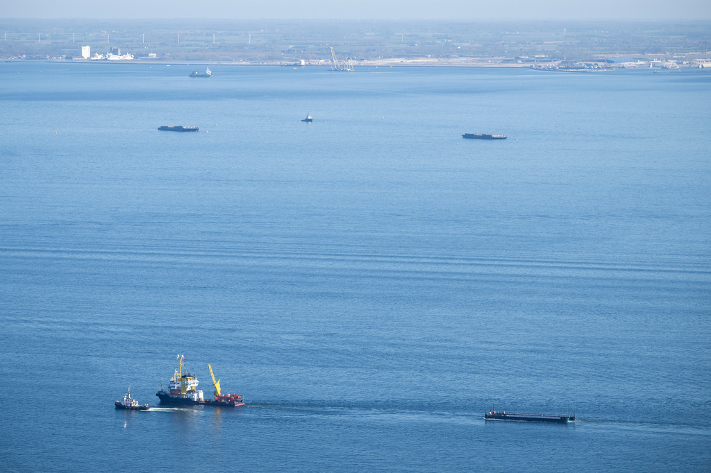 The humpback whale recovered from a shallow bay off Wismar is being transported towards the North Sea by two tugboats in a flooded cargo ship off the Danish coast, in Fehmarn, Germany, Wednesday, April 29, 2026. (Philip Dulian/dpa via AP)