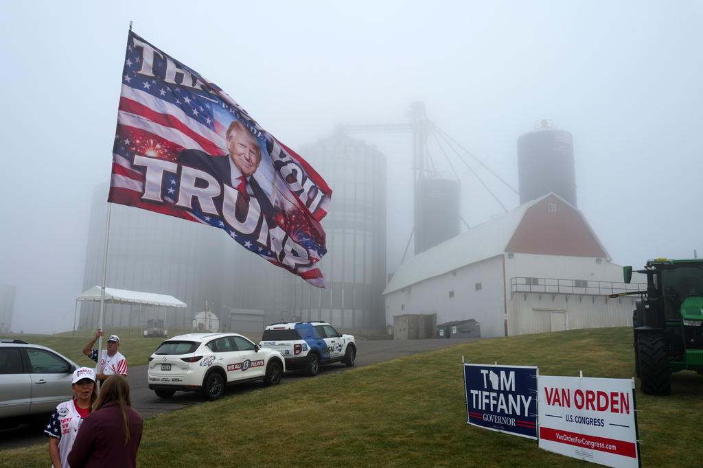 Attendees stand outside Custer Farms before President Donald Trump arrives to speak at an event, Friday, June 5, 2026, in Chippewa Falls, Wis. (AP Photo/Glen Stubbe)