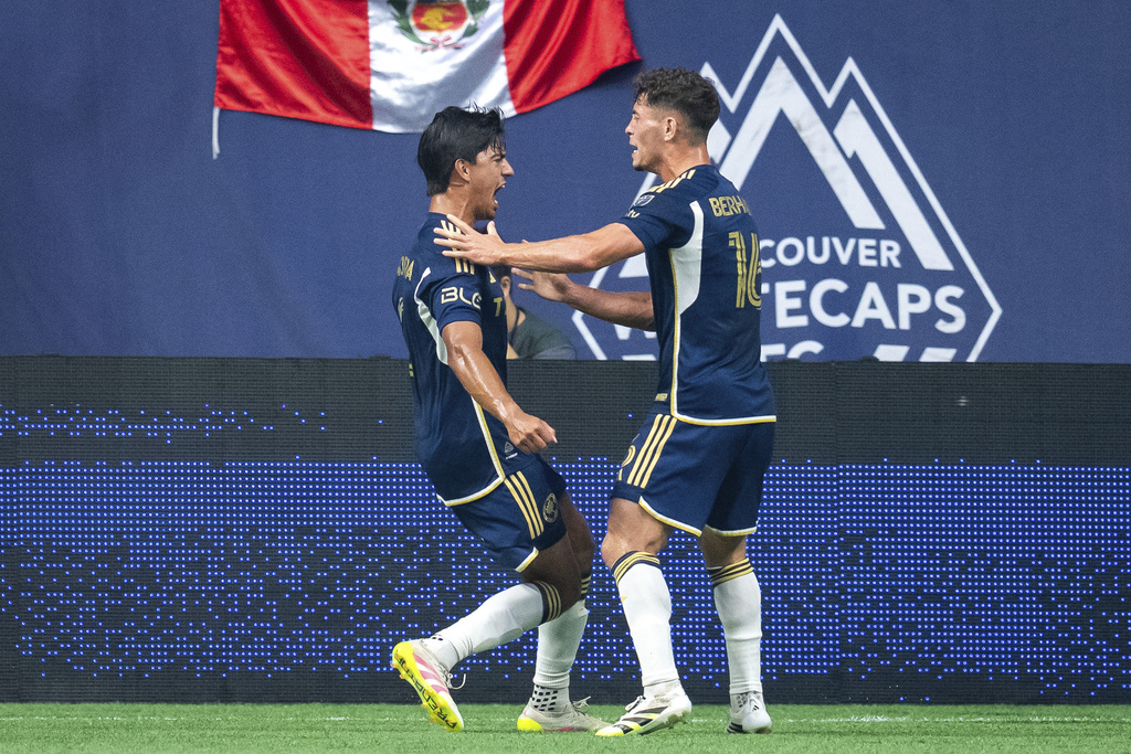 Vancouver Whitecaps' Mathias Laborda, left and Sebastian Berhalter celebrate Laborda's goal against the Philadelphia Union during the first half of an MLS soccer match in Vancouver, British Columbia, Saturday, Sept. 13, 2025. (Ethan Cairns/The Canadian Press via AP)