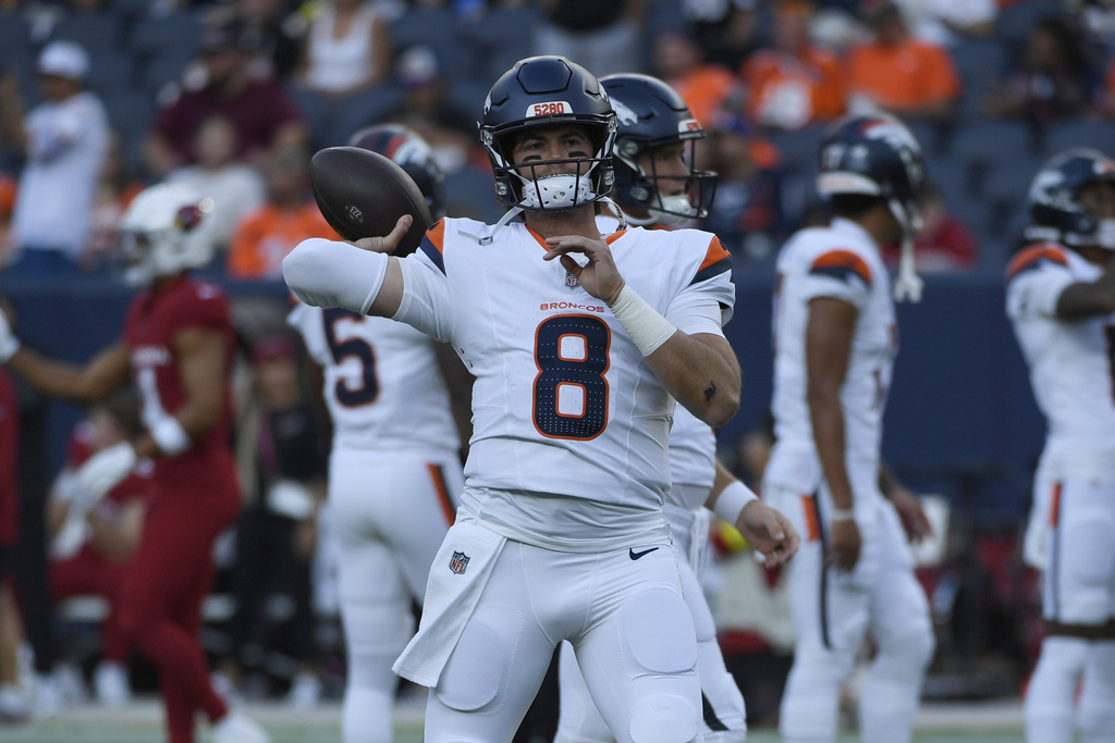 Denver Broncos quarterback Jarrett Stidham (8) throws before an NFL football preseason game against the Arizona Cardinals, Saturday, Aug. 16, 2025, in Denver. (AP Photo/Eric Lutzens)