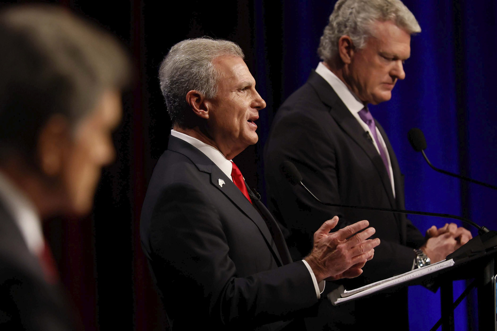 U.S. Rep. Buddy Carter, R-St. Simons Island, center, responds to a question from a panelist during the Atlanta Press Club Loudermilk-Young debate for the U.S. Senate at Georgia Public Broadcasting in Midtown, Atlanta, on Sunday, April 26, 2026. (Miguel Martinez/Atlanta Journal-Constitution via AP)