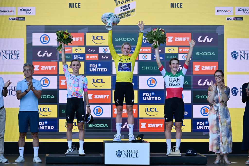 Winner Netherlands' Demi Vollering, centre, celebrates on the podium with Poland's Katarzyna Niewiadoma-Phinney, centre left, and Italy's Elisa Longo Borghini, centre right, after the Women's Tour de France cycling race (Tour de France Femmes) in Nice, France, Sunday, Aug. 9, 2026. (AP Photo/Philippe Magoni)
