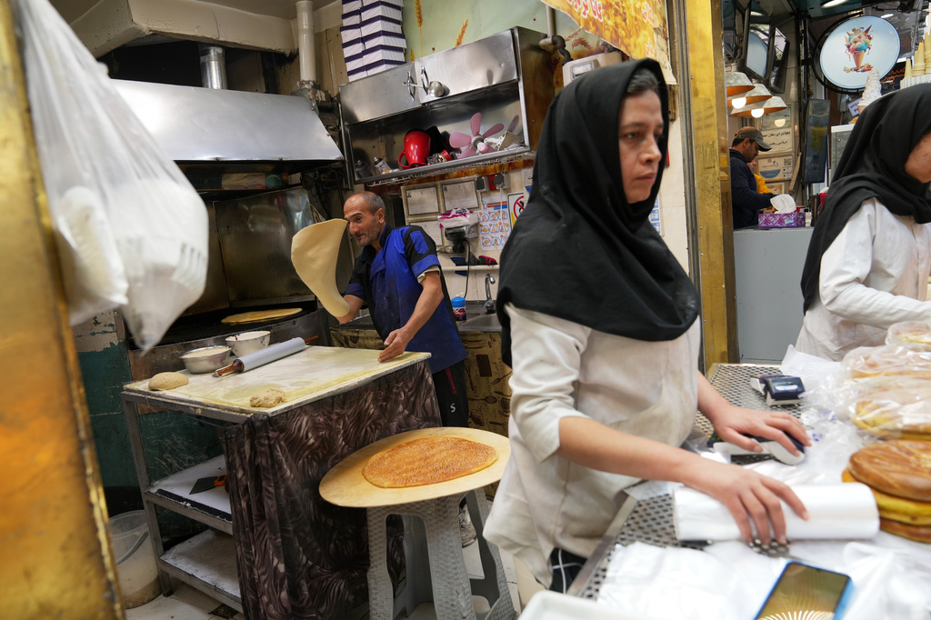 Employees work inside a bakery near Tajrish Bazaar in Tehran, Iran, Tuesday, April 7, 2026. (AP Photo/Francisco Seco)