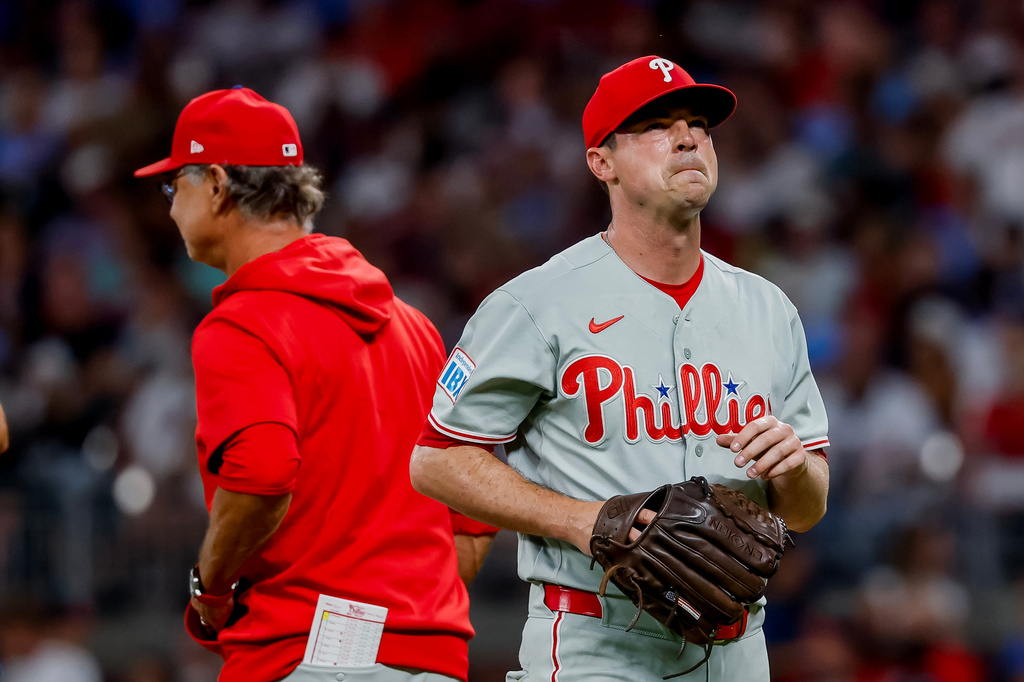 Philadelphia Phillies pitcher Brooks Raley, right reacts after getting relieved by interim manager Don Mattingly during the fourth inning of a baseball game against the Atlanta Braves, Saturday, Sept. 12, 2026, in Atlanta. (AP Photo/Erik S. Lesser)