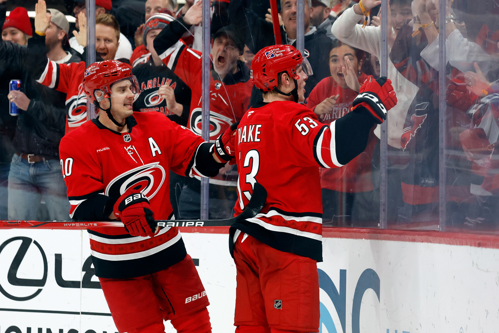 Carolina Hurricanes' Jackson Blake (53) celebrates after his winning overtime goal with Sebastian Aho (20) nearby following an overtime period of an NHL hockey game against the New York Rangers in Raleigh, N.C., Monday, Dec. 29, 2025. (AP Photo/Karl DeBlaker)