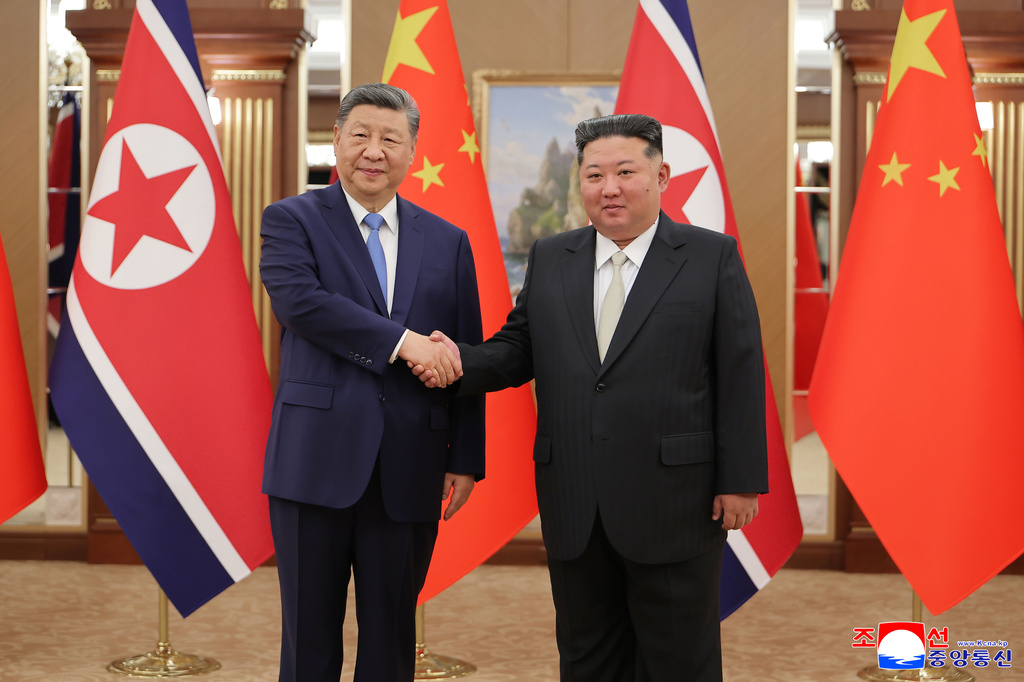 In this photo provided by the North Korean government, North Korean leader Kim Jong Un, right, and Chinese President Xi Jinping, left, shake hands ahead of their talk at Kumsusan State Guesthouse in Pyongyang, Monday, June 8, 2026. Independent journalists were not given access to cover the event depicted in this image distributed by the North Korean government. The content of this image is as provided and cannot be independently verified. Korean language watermark on image as provided by source reads: "KCNA" which is the abbreviation for Korean Central News Agency. (Korean Central News Agency/Korea News Service via AP)