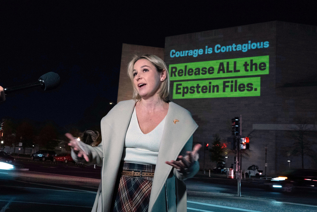 Danielle Bensky talks to reporters as a World Without Exploitation projection is seen on the wall of the National Gallery of Art calling on Congress to vote yes on the Epstein files transparency act in Washington, Monday, Nov. 17, 2025. (AP Photo/Jose Luis Magana)