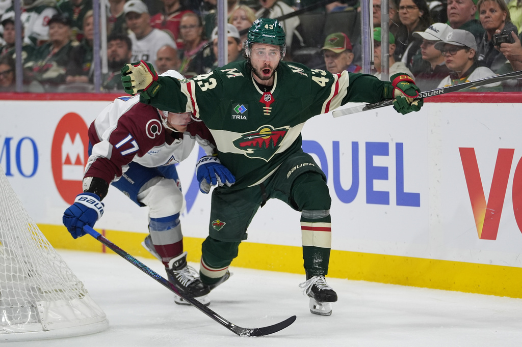 Minnesota Wild defenseman Quinn Hughes (43) looks toward a referee while defended by Colorado Avalanche center Parker Kelly (17) during the second period of Game 3 of an NHL Stanley Cup hockey second-round playoff series Saturday, May 9, 2026, in St. Paul, Minn. (AP Photo/Abbie Parr)