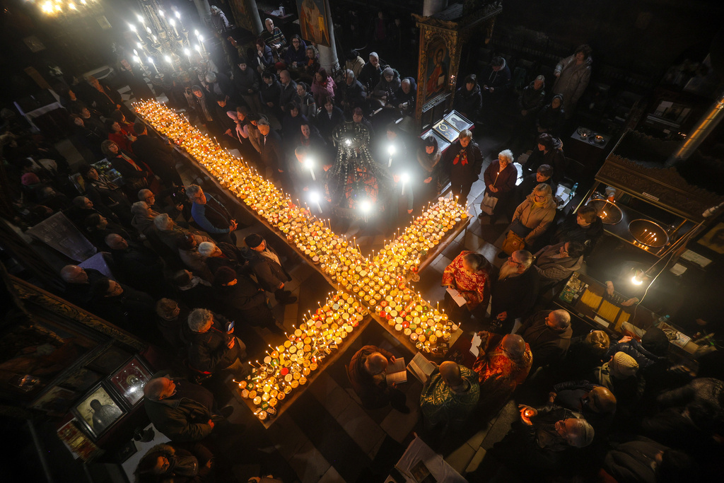 Believers attend an Orthodox service for the “sanctification of honey,” at the Presentation of the Blessed Virgin Church in the town of Blagoevgrad, Bulgaria, Tuesday, Feb.10, 2026, marking the feast day of St. Haralambos, the Orthodox patron saint of beekeepers. (AP Photo/Valentina Petrova)