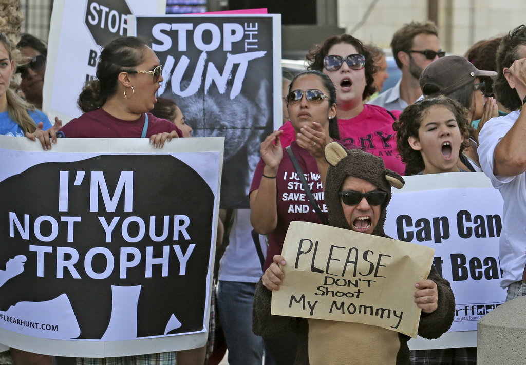 FILE - Protestors become vocal the day before a planned Florida Fish and Wildlife Conservation Commission bear hunt at a rally in Lake Eola Park in downtown Orlando, Fla., Oct. 23, 2015. (Red Huber/Orlando Sentinel via AP, file)