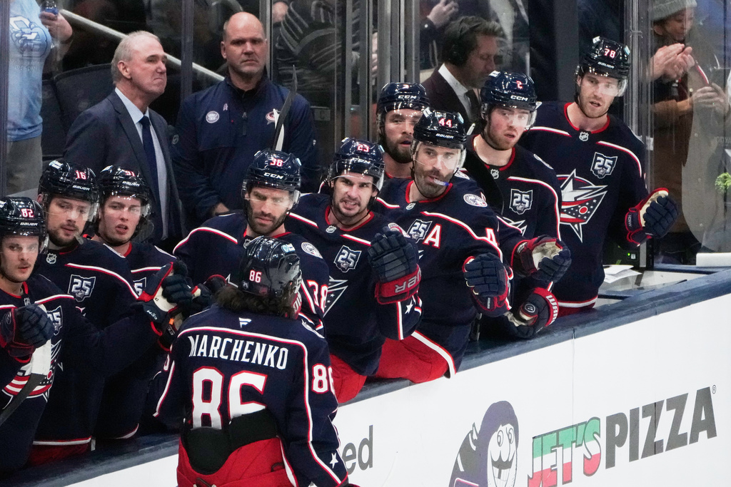 Columbus Blue Jackets right wing Kirill Marchenko (86) is congratulated after his goal in the second period of an NHL hockey game against the Vancouver Canucks, Thursday, Jan. 15, 2026, in Columbus, Ohio. (AP Photo/Sue Ogrocki)