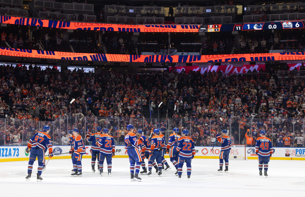 Edmonton Oilers players celebrate after a win over the Vancouver Canucks in an NHL hockey game in Edmonton, Alberta, Thursday April 16, 2026. (Jason Franson/The Canadian Press via AP)