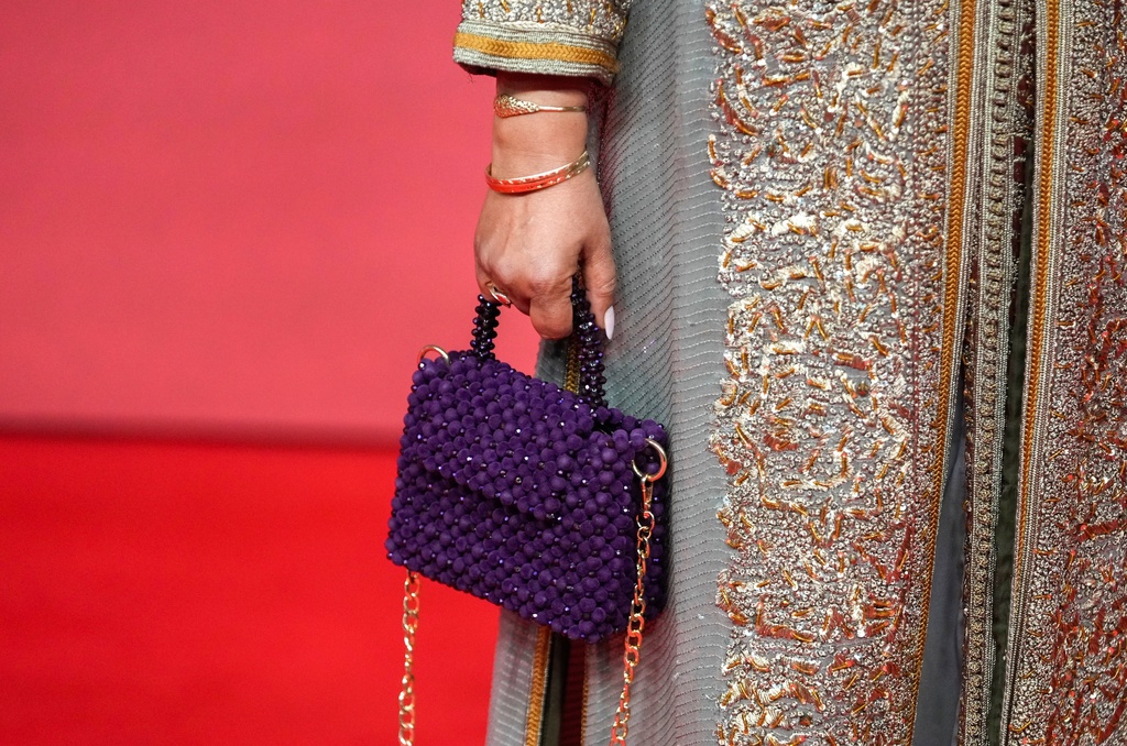 An actress poses for a photo on the red carpet during the 22nd Marrakech Film Festival, in Morocco, Tuesday, Dec. 2, 2025. (AP Photo/Mosa'ab Elshamy)