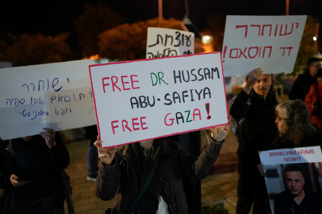 FILE - A woman holds a sign that reads "Free Dr. Hussam Abu Safiya, Free Gaza" during a protest in front of the Shin Bet offices, calling for his release, in Tel Aviv, Israel, on Jan. 1, 2025. (AP Photo/Matias Delacroix, File)