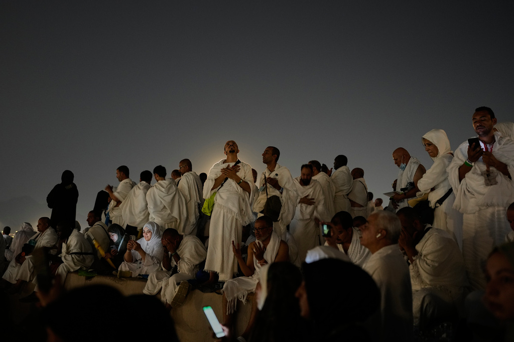 Muslim pilgrims pray at top of the rocky hill known as the Mountain of Mercy, on the Plain of Arafat, during the annual Hajj pilgrimage near the holy city of Mecca, Saudi Arabia, Tuesday, May 26, 2026. (AP Photo/Altaf Qadri)