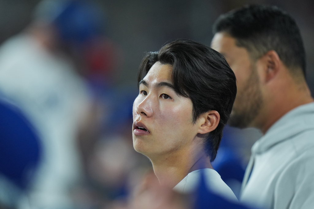 Los Angeles Dodgers' Hyeseong Kim watches from the dugout during the third inning of a baseball game against the New York Mets Wednesday, April 15, 2026, in Los Angeles. (AP Photo/Jae C. Hong)