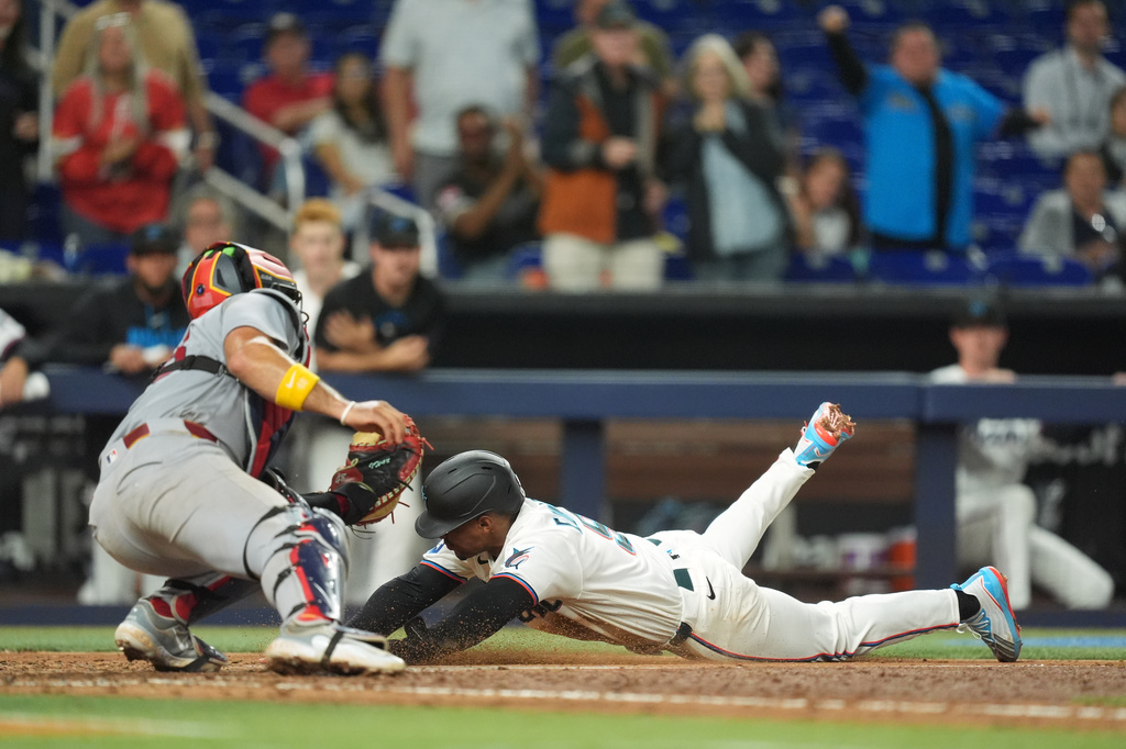 St. Louis Cardinals catcher Ivan Herrera tags out Miami Marlins' Xavier Edwards as he slides home on a single by Liam Hicks, during the sixth inning of a baseball game, Monday, April 20, 2026, in Miami. (AP Photo/Rebecca Blackwell)