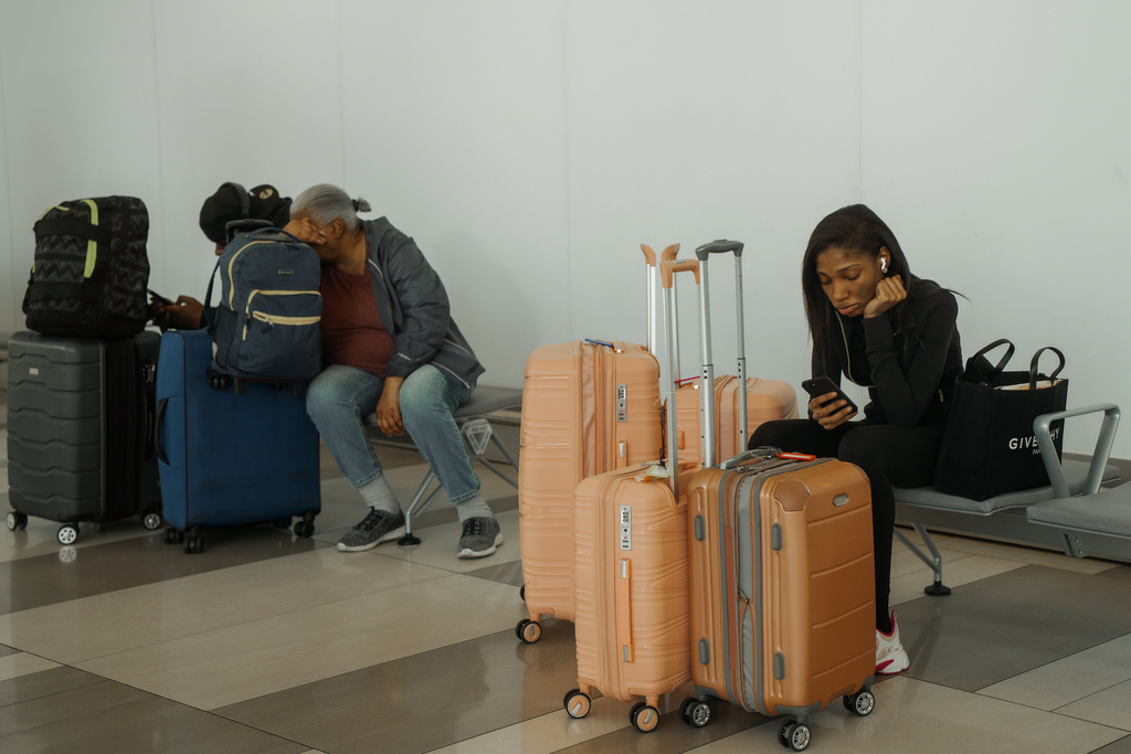 Travelers wait at LaGuardia International Airport in New York, Saturday, Nov. 8, 2025. (AP Photo/Olga Fedorova)
