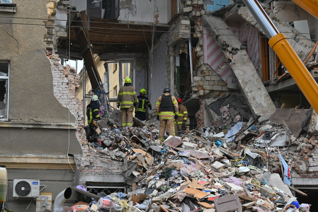 Rescue workers clear the rubble of a residential building which was heavily damaged after a Russian strike in Odesa, Ukraine, Tuesday, Jan. 27, 2026. (AP Photo/Michael Shtekel)