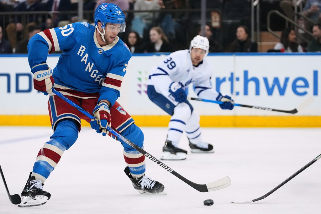 New York Rangers' Will Cuylle (50) drives past Toronto Maple Leafs' Nicholas Robertson (89) during the first period of an NHL hockey game Thursday, March 5, 2026, in New York. (AP Photo/Frank Franklin II)