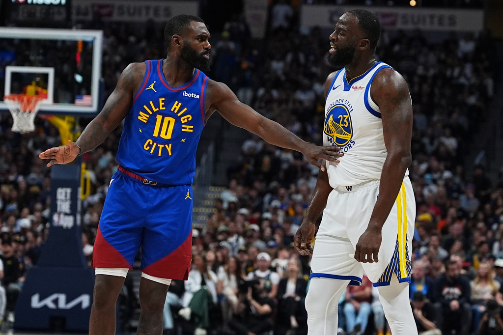 Denver Nuggets guard Tim Hardaway Jr., left, exchanges words with Golden State Warriors forward Draymond Green in the first half of an NBA basketball game Sunday, March 29, 2026, in Denver. (AP Photo/David Zalubowski)