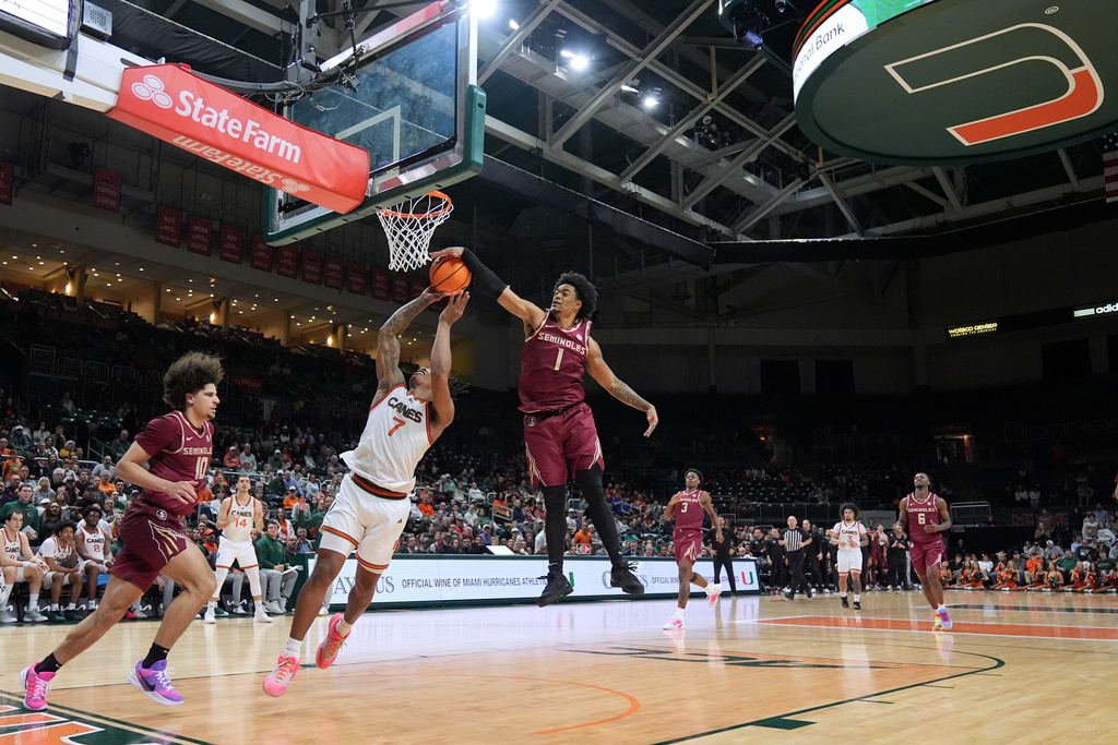 Florida State guard Martin Somerville (1) snuffs a shot by Miami forward Shelton Henderson (7) as Florida State guard Lajae Jones (10) pressures during the second half of an NCAA college basketball game, Tuesday, Jan. 20, 2026, in Coral Gables, Fla. (AP Photo/Rebecca Blackwell)
