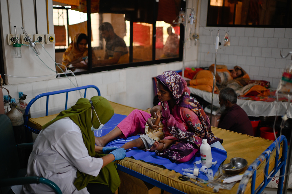 A nurse treats a child suffering from measles at the Infectious Diseases Hospital in Dhaka, Bangladesh, Monday, April 6, 2026, amid a countrywide outbreak. (AP Photo/Mahmud Hossain Opu)