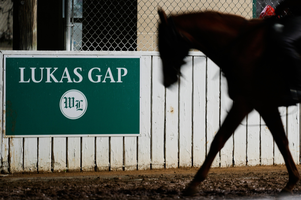 A horse comes off the track through the Lukas Gap gate, named in honor of deceased Hall of Fame trainer D. Wayne Lukas, Wednesday, April 29, 2026, at Churchill Downs in Louisville, Ky. (AP Photo/Charlie Riedel)