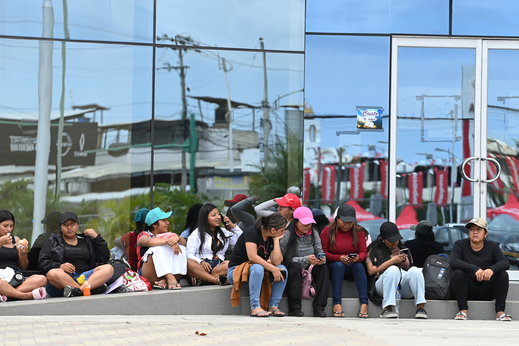 Women wait for information about the expected arrival of their relatives who were aboard the Maria Candelaria, a vessel intercepted two days prior by U.S. authorities on suspicion of alleged drug trafficking, outside a police station in Manta, Ecuador, Monday, Sept. 7, 2026. (AP Photo/Ariel Ochoa)