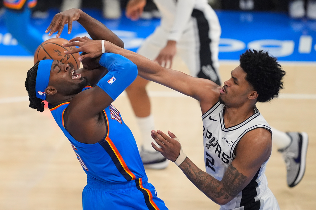 San Antonio Spurs guard Dylan Harper (2) defends against Oklahoma City Thunder guard Luguentz Dort (5) during the first half of Game 2 in the Western Conference finals NBA basketball playoffs series Wednesday, May 20, 2026, in Oklahoma City. (AP Photo/Tony Gutierrez)
