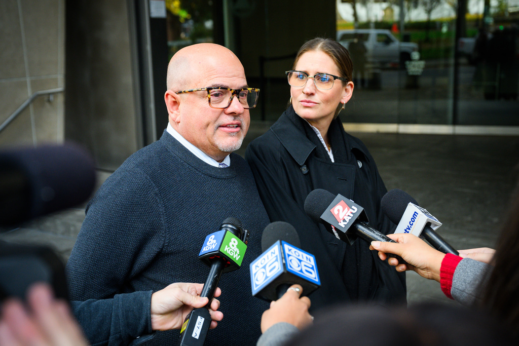 Mike Tacconi, left, and Carmen Loeffler, right, friends of former Alaska Airlines pilot Joseph Emerson, speak in support of Emerson following his sentencing at the U.S. District Court in Portland, Ore., Monday, Nov. 17, 2025. (AP Photo/Molly J. Smith)