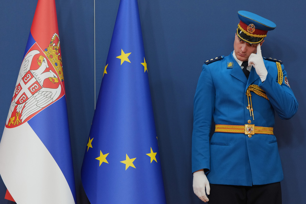 A member of the Serbian honour guard prepares by an EU flag prior visit of European Commission President Ursula von der Leyen at the Serbia Palace in Belgrade, Serbia, Wednesday, Oct. 15, 2025. (AP Photo/Darko Vojinovic)