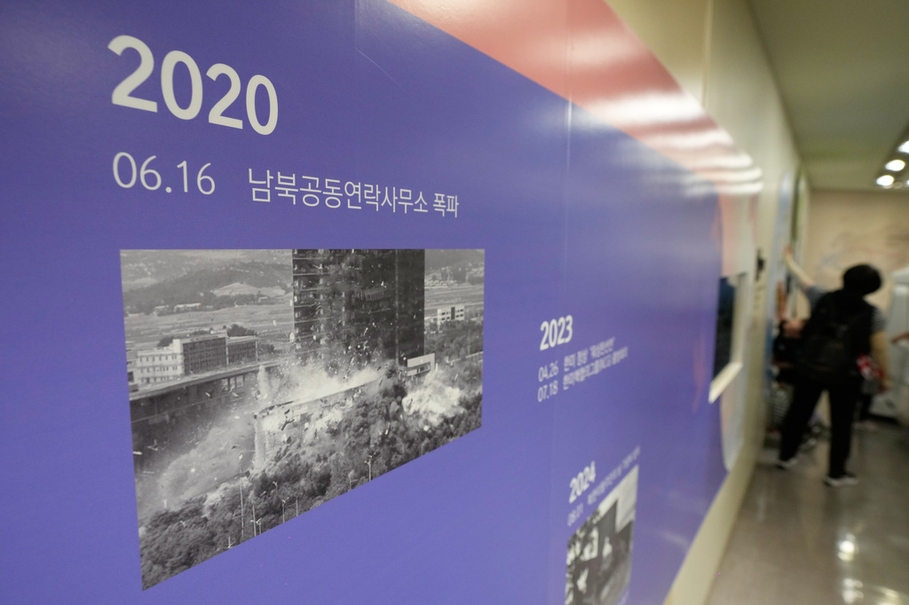 A photo showing the demolition of an inter-Korean liaison office building in Kaesong, North Korea, is displayed at the Unification Observation Post in Paju, South Korea, near the border with North Korea, Wednesday, Sept. 16, 2026. The signs read ''The demolition of an inter-Korean liaison office building.'' (AP Photo/Ahn Young-joon)