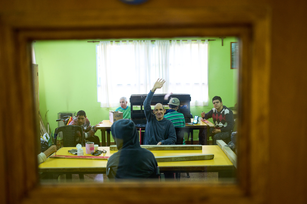 A resident cheers while attending a woodworking class at the Pequeño Cottolengo Don Orione, a home for people with disabilities that will be visited by Pope Leo XIV in November, in Buenos Aires, Argentina, Thursday, Sept. 24, 2026. (AP Photo/Rodrigo Abd)