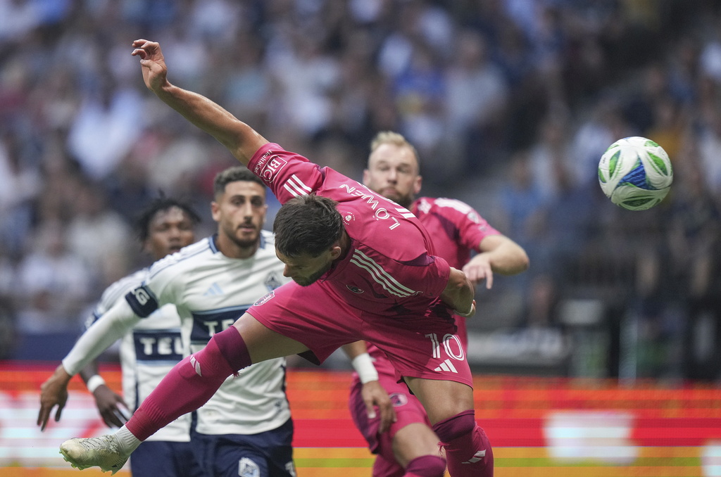 St. Louis City's Eduard Lowen gets his head on the ball and scores against the Vancouver Whitecaps during the first half of an MLS soccer match, in Vancouver, on Saturday, August 23, 2025. (Darryl Dyck/The Canadian Press via AP)