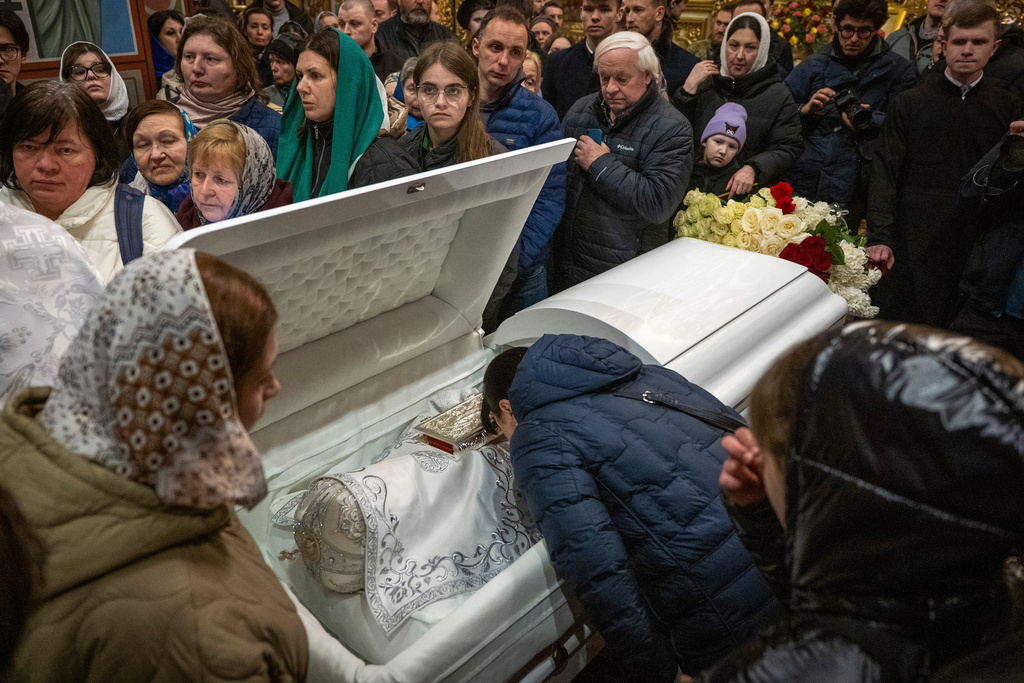 Mourners pray during a funeral service for Patriarch Emeritus Filaret of Ukraine's Orthodox Church in St. Michael Cathedral in Kyiv, Ukraine, Friday, March 20, 2026. (AP Photo/Dan Bashakov)