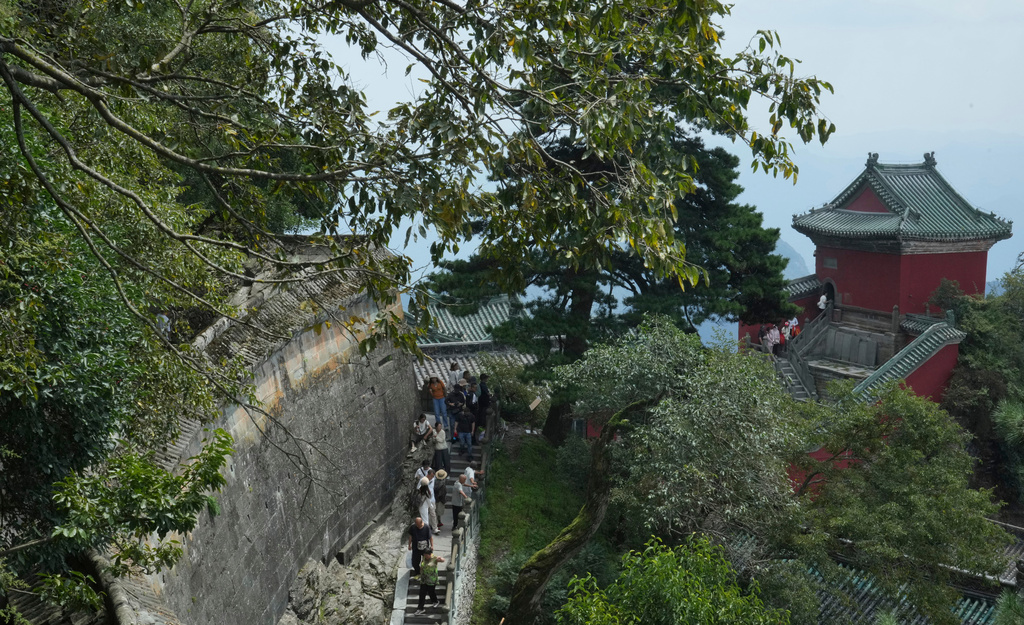 Visitors walk near a temple in Wudang Mountains in central China's Hubei Province on Sept. 3, 2026. (AP Photo/Achmad Ibrahim)