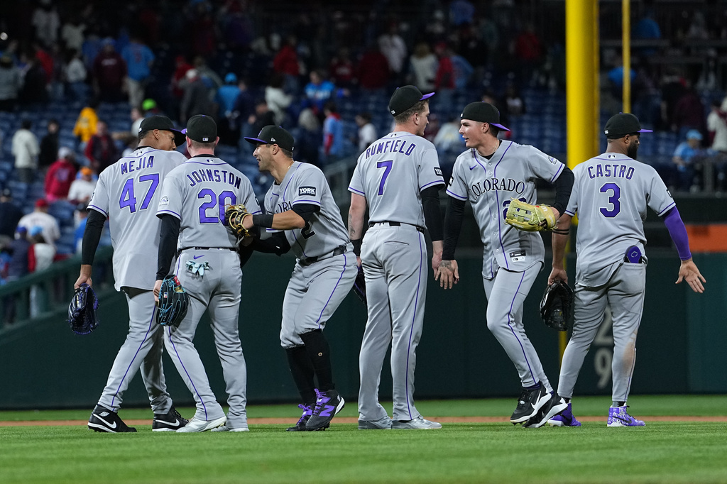 The Colorado Rockies celebrate their win after a baseball game against the Philadelphia Phillies, Friday, May 8, 2026, in Philadelphia. (AP Photo/Matt Rourke)