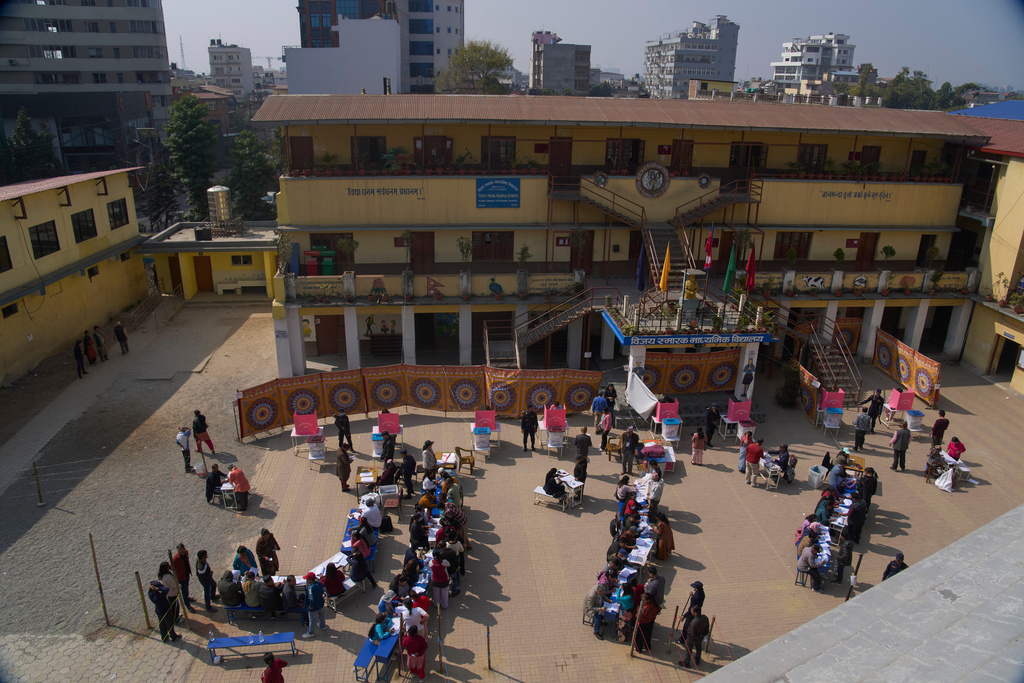 Nepalese people stand in a queue to cast their vote at a polling station for the parliamentary election in Kathmandu, Nepal, Thursday, March 5, 2026. (AP Photo/Niranjan Shrestha)