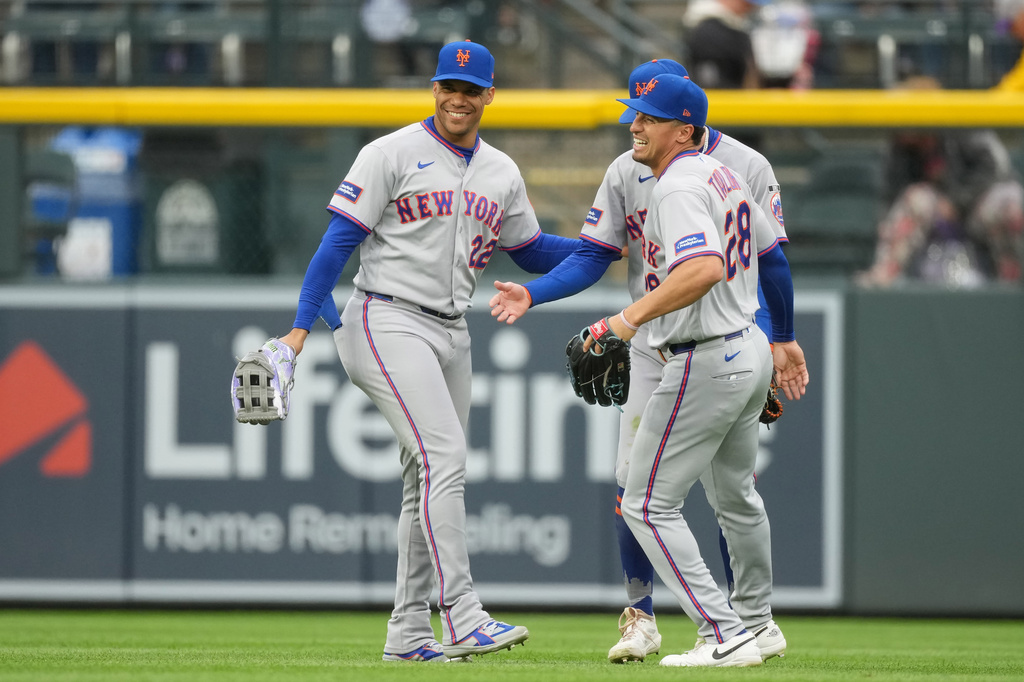 From left to right, New York Mets left fielder Juan Soto, center fielder Carson Benge and right fielder Tyrone Taylor celebrate after their team defeated the Colorado Rockies in a baseball game Monday, May 4, 2026, in Denver. (AP Photo/David Zalubowski)