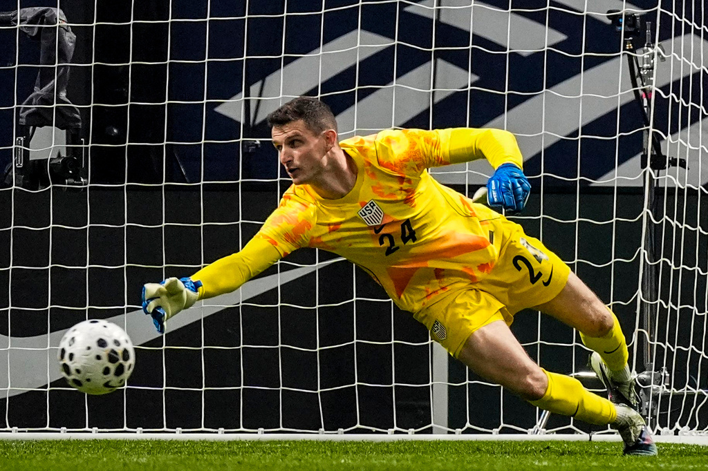 USA goalkeeper Matt Freese (24) misses the ball as Portugal's Francisco Trincao scores a goal during the first half of an international friendly soccer match, Tuesday, March 31, 2026, in Atlanta. (AP Photo/Mike Stewart)