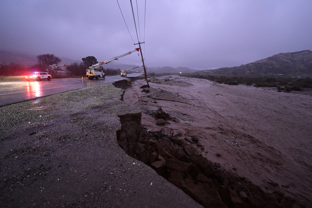 Damage is seen to a closed California State Route 138 after flooding Wednesday, Dec. 24, 2025, outside of Wrightwood, Calif. (AP Photo/Wally Skalij)
