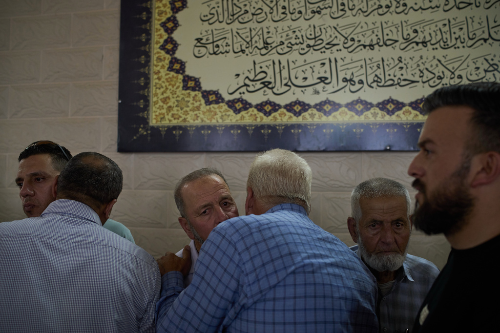 Hussein Ramadan, center left, father of two Palestinians killed by Israeli forces the previous day receives condolences from friends and neighbours in the village of Tell, near the West Bank city of Nablus, Saturday, July 25, 2026. (AP Photo/Leo Correa)