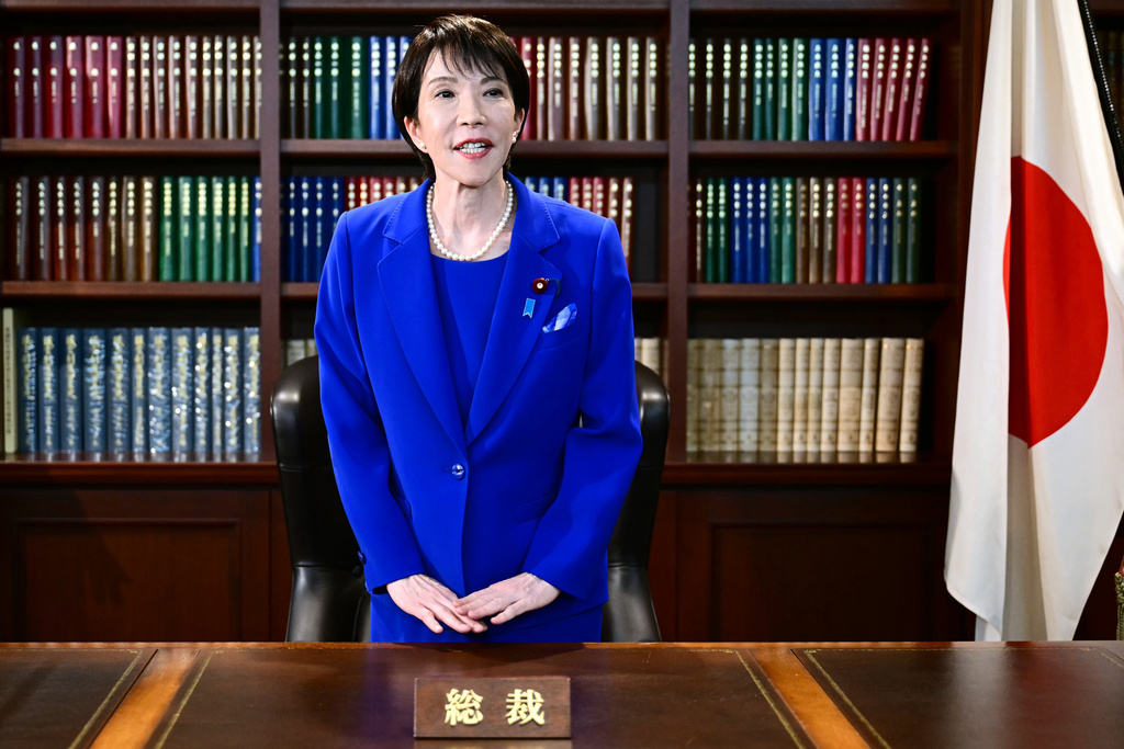 FILE - Sanae Takaichi, the newly-elected leader of Japan's ruling party, the Liberal Democratic Party (LDP), gestures as she leaves the party leader's office after the LDP leadership election in Tokyo Saturday, Oct. 4, 2025. (Yuichi Yamazaki/Pool Photo via AP, File)