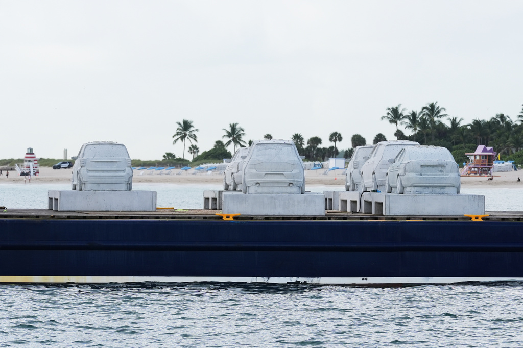 Concrete cars wait to the submerged off South Beach to become an underwater sculpture park Tuesday, Oct. 28, 2025, in Miami Beach, Fla. Native corals grown in a lab will be attached to the cars to create a reef. (AP Photo/Marta Lavandier)